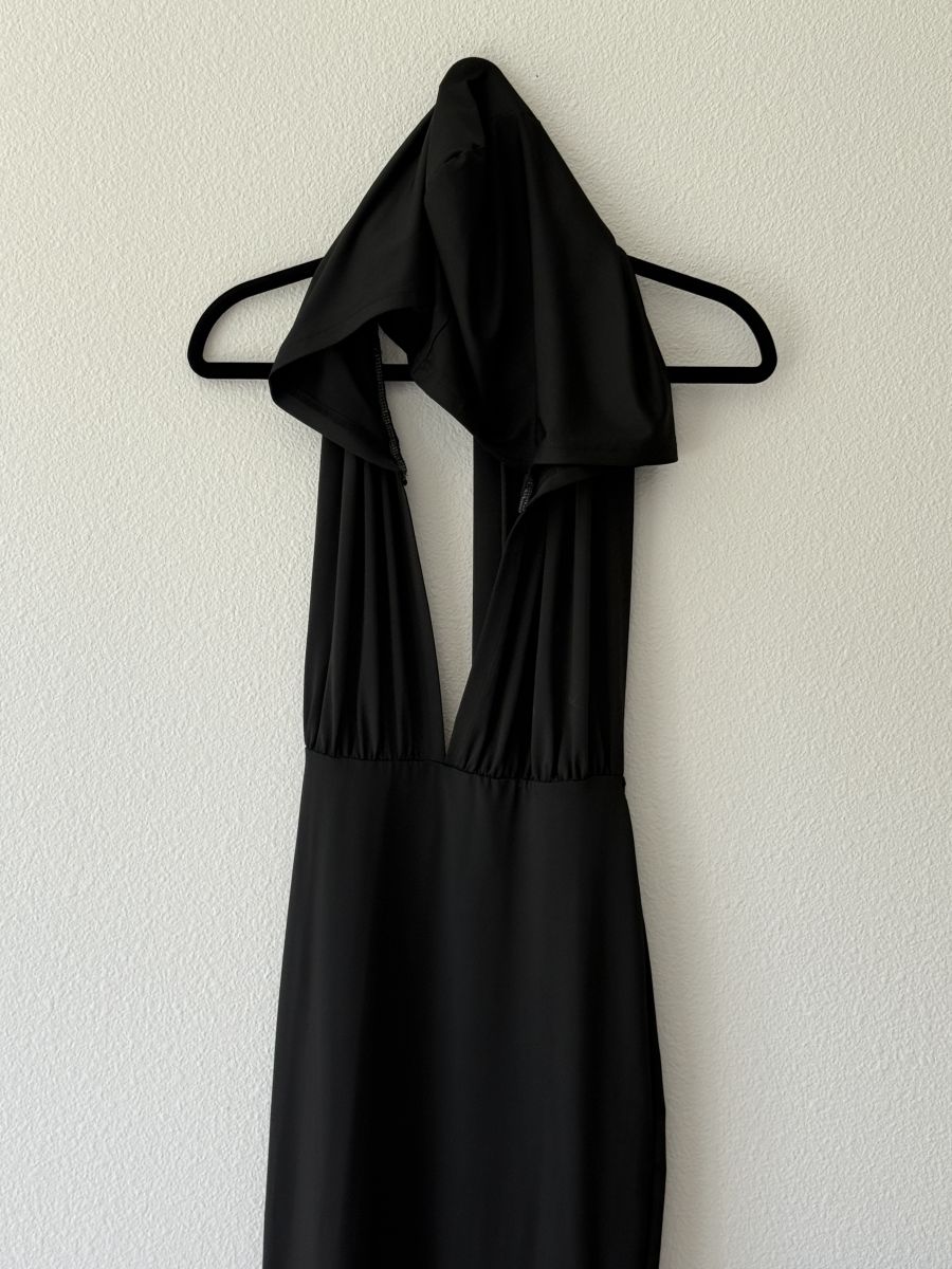 Black halter dress with deep plunge neckline and draped hood detail.